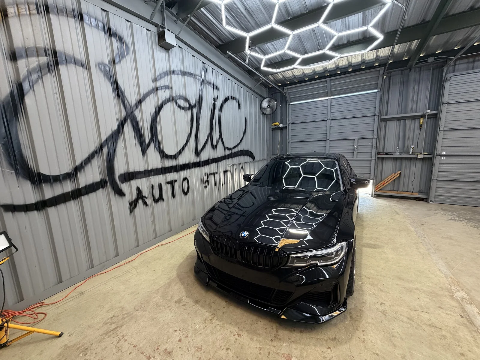Inside Exotic Auto Studio — detail bay and work area